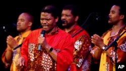 South African singing group Ladysmith Black Mambazo performs Sunday, April 10, 2005, at Town Hall in New York. Leader and founder Joseph Shabalala,center, sings in front of the others in the group.. (AP Photo/Chad Rachman)