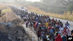 FILE —Migrants walk along the highway through Arriaga, Chiapas state in southern Mexico, January 8, 2024, during their journey north toward the U.S. border.