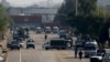 Security vehicles park near shipping containers placed by authorities on a highway to stop supporters of the 'Tehreek-e-Labaik Pakistan, a religious political party, entering into the capital during an anti-France rally in Islamabad, Nov. 16, 2020.