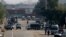 Security vehicles park near shipping containers placed by authorities on a highway to stop supporters of the Tehreek-e-Labaik Pakistan, a religious political party, entering into the capital during an anti-France rally in Islamabad, Nov. 16, 2020.
