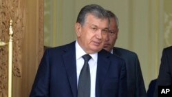 Uzbekistan's Shavkat Mirziyoyev speaks with Russian President Vladimir Putin (not pictured) in Samarkand, Uzbekistan, Sept. 6, 2016.