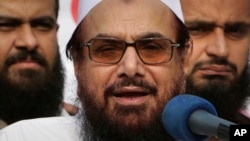 FILE - Hafiz Saeed, founder and leader of Lashkar-e-Tayyiba, a U.S.-designated global terror group, addresses an anti-Indian rally in Lahore, Pakistan, on Oct. 26, 2018. India announced on Dec. 29, 2023, that it has asked Pakistan to extradite Saeed in a "money laundering case."