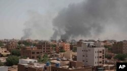 FILE - Smoke rises from a central neighborhood of Khartoum, Sudan, Sunday, April 16, 2023, after dozens have been killed in two days of intense fighting. 