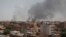 FILE - Smoke rises from a central neighborhood of Khartoum, Sudan, Sunday, April 16, 2023, after dozens have been killed in two days of intense fighting. 