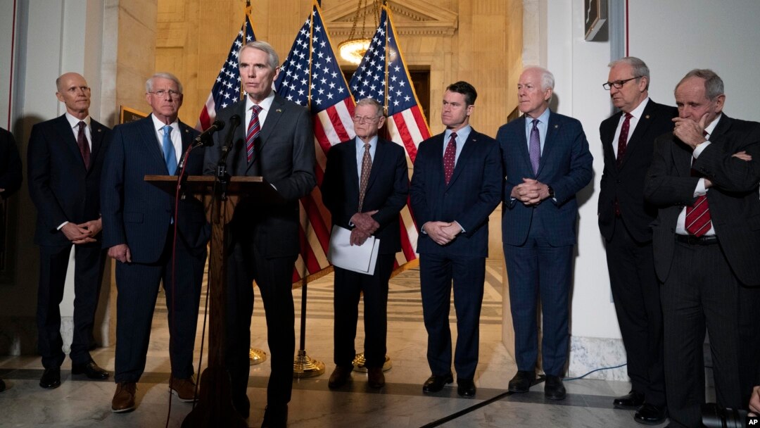 Republican Senator Rob Portman, center, standing with with other senators, speaks during a news conference on Capitol Hill in Washington, Jan. 19, 2022.