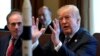 With a rocket ship on the table, U.S. President Donald Trump speaks during a cabinet meeting at the White House in Washington, March 8, 2018. 