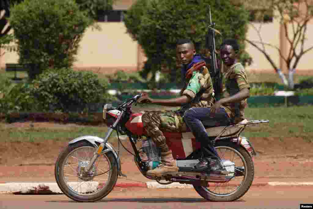 Seleka soldiers ride a motorcycle during fighting in Bangui, Central African Republic, Dec. 5, 2013.