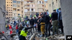 Rescuers search for victims at the site of an Israeli airstrike that targeted a building in Beirut, Lebanon, Nov. 26, 2024. 