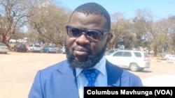 Jeremiah Bamu, of Zimbabwe Lawyers for Human Rights, speaks outside the Harare Magistrates Court, on Sept. 4, 2024.