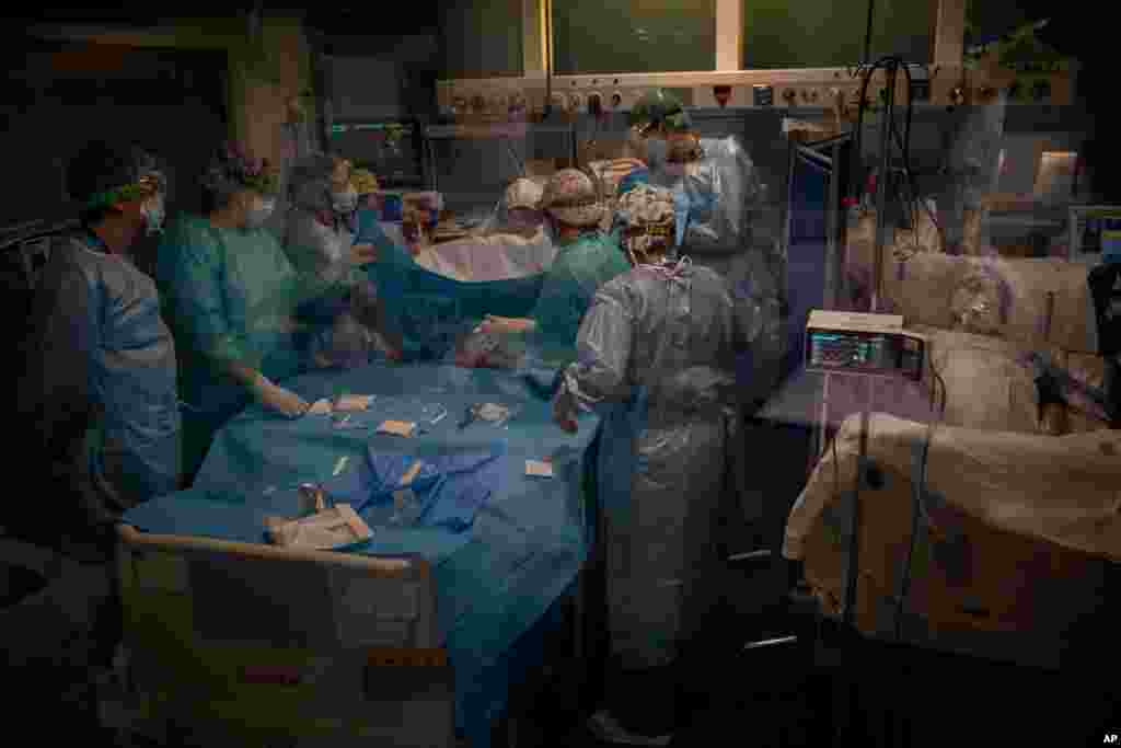 Doctors perform a tracheotomy on a COVID-19 patient in critical care in the Intensive Care Unit at Barcelona&#39;s Hospital del Mar, Spain.