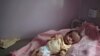 A malnourished boy lies in a bed waiting to receive treatment at a feeding center at Al-Sabeen hospital in Sanaa, Yemen, June 27, 2020. 