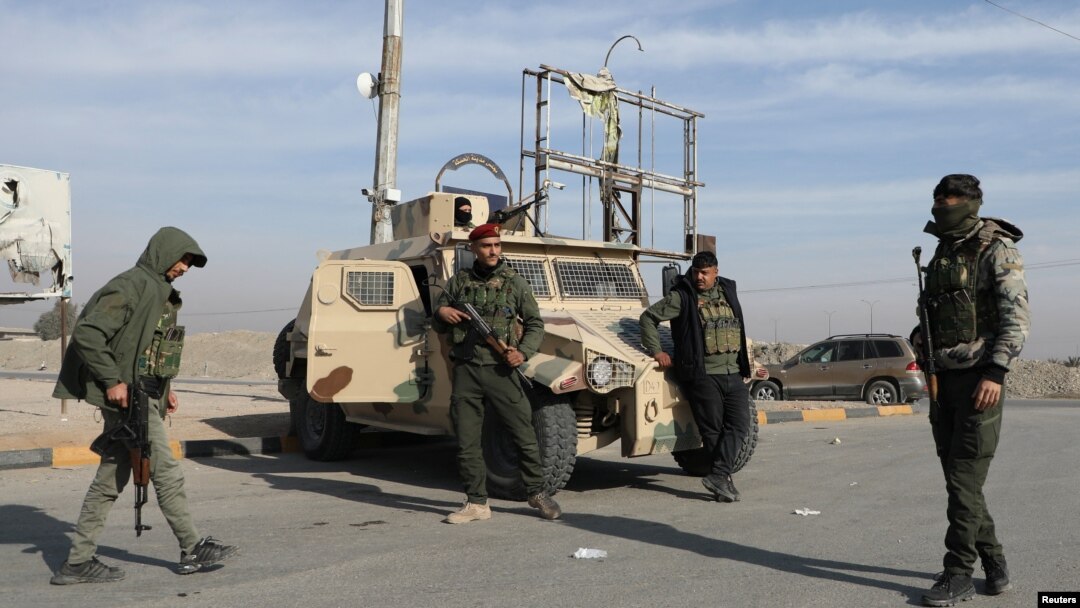 Members of Kurdish-led Syrian Democratic Forces stand along a street after rebels seized the capital and ousted Syria's Bashar al-Assad, in Hasakah, Syria, Dec. 11, 2024.