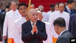 Cambodia's King Norodom Sihamoni, center, greets nation's lawmakers before a photo session in front of the National Assembly in Phnom Penh, Cambodia, Monday, Aug. 21, 2023. On Monday he presided over the opening of the first session of National Assembly in Phnom Penh. 