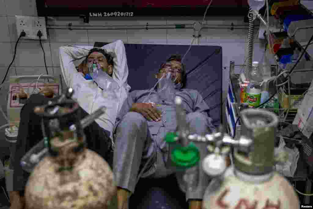 Patients suffering from the COVID-19 get treatment in Lok Nayak Jai Prakash (LNJP) hospital, in New Delhi, India.