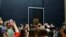 Tourists wait to see Leonardo da Vinci's painting Mona Lisa, at the Louvre museum, in Paris, Oct. 23, 2019.