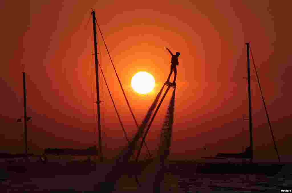 A man practices flyboarding near the village of Olenevka, Crimea, Aug. 5, 2017.