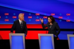 FILE - Senator Kamala Harris, right, speaks as former Vice President Joe Biden listens during the second of two Democratic presidential primary debates hosted by CNN, in the Fox Theatre in Detroit, Michigan, July 31, 2019.