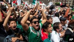 Fans celebrate Mexico's win during the Mexico vs. Germany World Cup football match, as they watched it on an outdoor screen in Mexico City, Mexico, June 17, 2018.