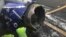 The engine on a Southwest Airlines plane is inspected as it sits on the runway at the Philadelphia International Airport after it made an emergency landing in Philadelphia, April 17, 2018.