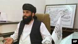 FILE - Suhail Shaheen gives an interview in Islamabad, Nov. 14, 2001. The Taliban spokesman says the seventh and latest round of peace talks with the U.S. is "critical," as the militant group meets with Washington's envoy Zalmay Khalilzad in Qatar.