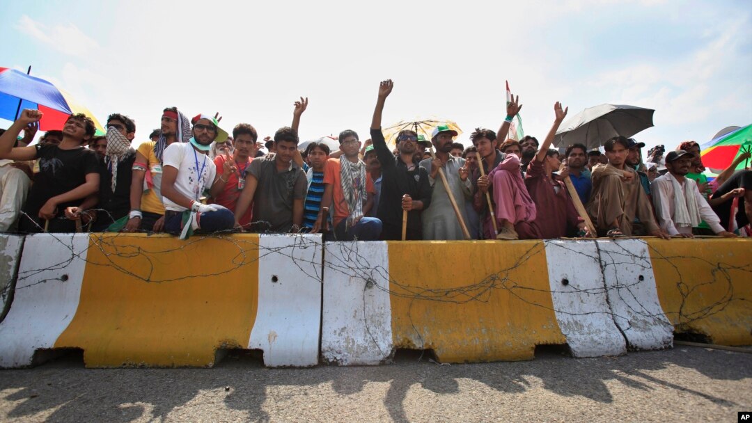 Supporters of anti-government cleric Tahir-ul-Qadri block an entrance of the parliament during a protest at Islamabad's high-security Red Zone in Islamabad, Pakistan, Aug. 20, 2014.