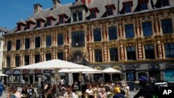 People enjoy a meal in a terrace restaurant during the nationwide reopening of restaurants, in Lille, northern France, June 9, 2021. 