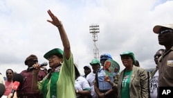 Liberian President Ellen Johnson Sirleaf gestures to supporters as she speaks following a prayer service on the final day of campaigning ahead of presidential elections, in Monrovia, October 9, 2011.