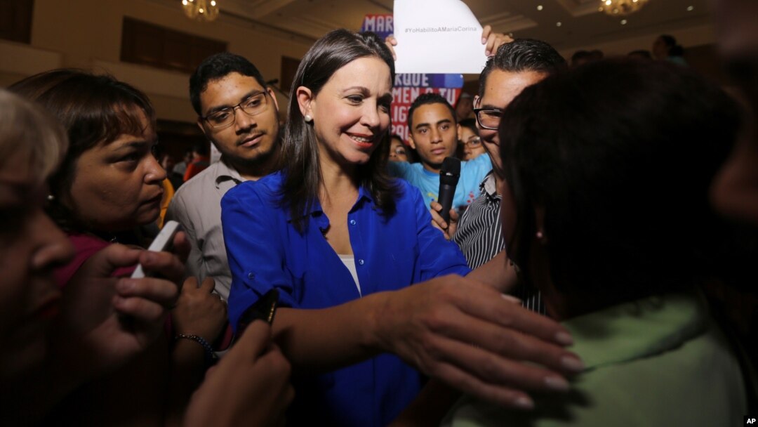 FILE - Venezuelan opposition politician Maria Corina Machado, shown greeting supporters after a news conference in Caracas, on July 15, 2015, says she's been barred from holding public office ahead of December's congressional election.