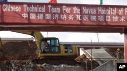 FILE - A construction crew works on a site where a new hospital is planned, in Navua, Fiji.