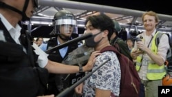 Policemen in riot gears arrest a protester during a demonstration at the Airport in Hong Kong, Aug. 13, 2019. 