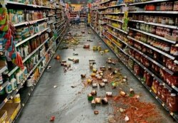 Food that fell from the shelves litters the floor of an aisle at a Walmart following an earthquake in Yucca Yalley, Calif., 155 miles from Ridgecrest, where a magnitude 7.1 quake struck, July 5, 2019.