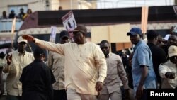 Senegal's President and candidate for the upcoming presidential elections Macky Sall greets his supporters during his campaign rally In Guediawaye, Senegal, Feb. 20, 2019.