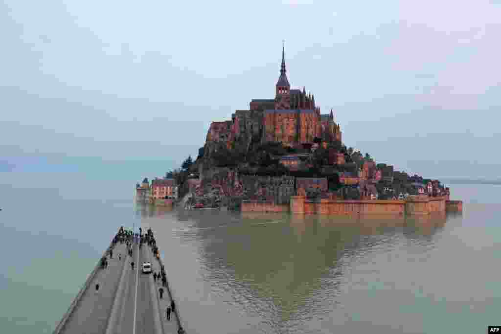 A road is partially covered with water during high tide at the Mont-Saint-Michel, in Normandy, northwestern France.