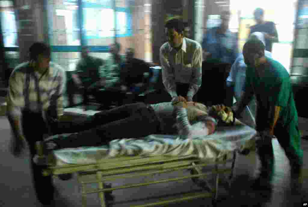 A wounded man arrives at a hospital after a bomb exploded near a national security building in the Shubra el-Kheima neighborhood of Cairo, Aug. 20, 2015.