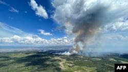 This July 27, 2023, aerial image from the British Columbia Wildfire Service, shows smoke from the the Ross Moore wildfire south of Kamloops, British Columbia, Canada.