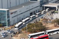 Buses carrying some South Korean evacuees from Wuhan, China, leave after arriving at Gimpo airport in Seoul, South Korea, Jan. 31, 2020. South Korea has set up two quarantine in Asan and Jincheon, much to the disapproval of the cities' residents.