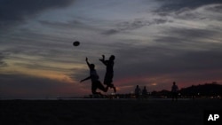 FILE - People play ultimate frisbee on the beach, April 11, 2018, in Santa Barbara, California. 