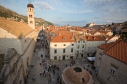 FILE - In this Sept. 7, 2018 photo, tourists walk through Dubrovnik. Crowds are clogging the entrances into the ancient walled city, a UNESCO World Heritage Site, used as a major location for "Game of Thrones."