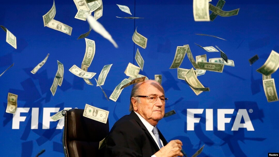 British comedian Lee Nelson (unseen) throws banknotes at FIFA President Sepp Blatter as he arrives for a news conference after the Extraordinary FIFA Executive Committee Meeting in Zurich, Switzerland, July 20, 2015.