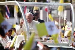 Pope Francis waves to the crowd following his visit to St. Peter's Parish church in the Sam Phran district of Nakhon Pathom Province, Thailand, Nov. 22, 2019.