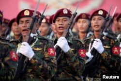 FILE - Soldiers take part in a military parade to mark Armed Forces Day, in the capital Naypyitaw, Myanmar, March 27, 2019.