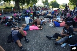 Migrants, part of a caravan heading toward the country's northern border and ultimately the United States, rest on the outskirts of Escuintla, southern Mexico, Nov. 7, 2024.