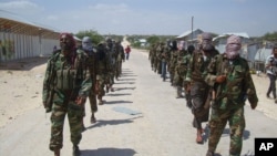 FILE - Members of Somalia's al- Shabab militant group patrol on foot on the outskirts of Mogadishu, Somalia, March 5, 2012. The U.S. military said Wednesday it has resumed airstrikes against the extremist group.