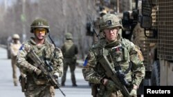 FILE - British soldiers with NATO-led Resolute Support Mission arrive at the site of an attack in Kabul, Afghanistan, March 6, 2020. 