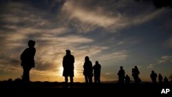 People wait in line to vote at a polling place before it opened on Election Day in Las Vegas, Nevada.