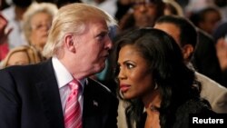 FILE - Republican presidential nominee Donald Trump and Omarosa Manigault attend a church service in Detroit, Michigan, Sept. 3 2016. 