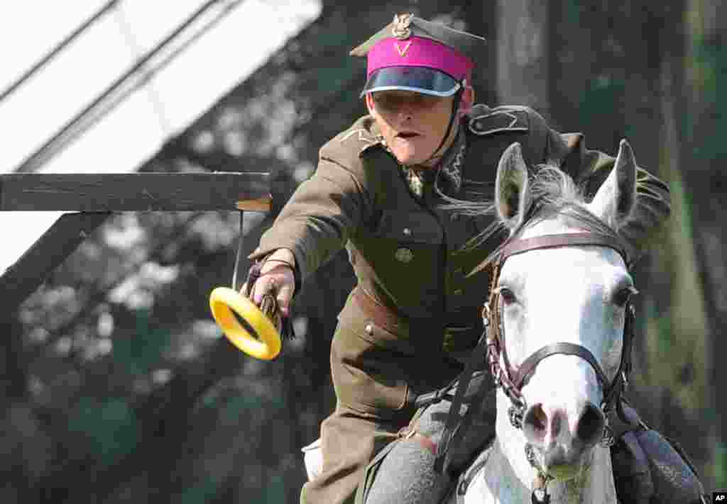 A soldier on horseback performs a sword attack during the Cavalry Day show in Warsaw, Poland.