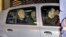 Portugal's former Prime Minister Jose Socrates, in the back seat of the car on the left, leaves a court in a Portuguese police car after being questioned, in Lisbon, Sunday, Nov. 23, 2014.
