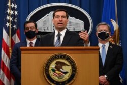 Assistant Attorney General John C. Demers speaks during a press conference to announce that two alleged Islamic State militants will arrive in the U.S. to face trial, at the Justice Department in Washington, Oct. 7, 2020.