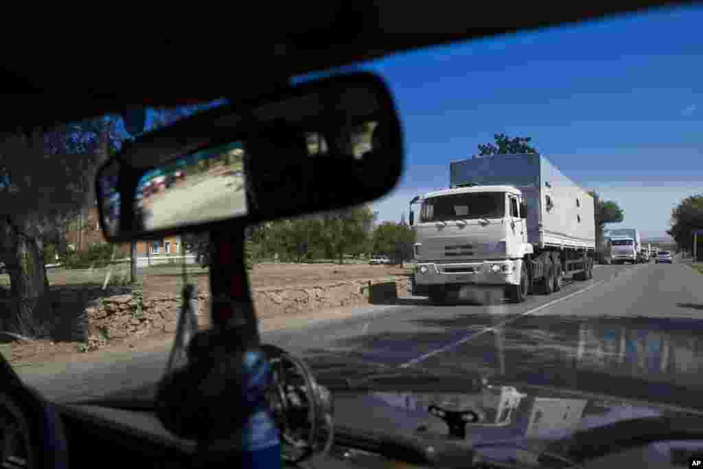 Trucks move toward a border-control point between Russia and Ukraine in the Russian Rostov-on-Don region, near the Donetsk region, Ukraine. The first trucks of the Russian aid convoy crossed the Ukrainian inspection zone Friday morning.